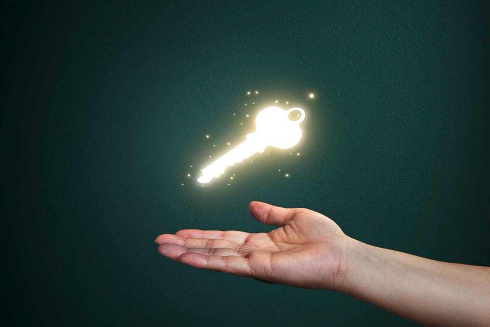 A glowing key in a person's hand.